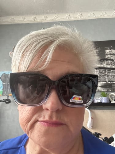 Close-up of a reviewer wearing the oversized Polarized Fit Over Sunglasses over her prescription glasses.