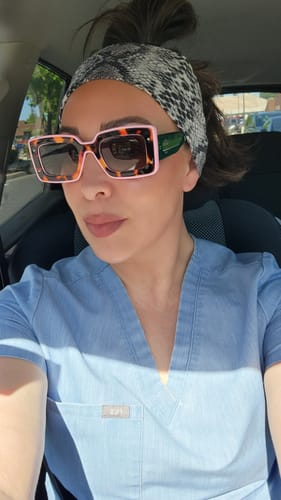 Customer wearing stylish, color-block Deco Sunglasses in a car.