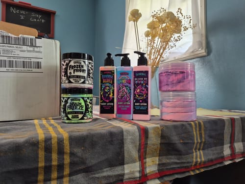 Customer's Brain Freeze Sugar Scrub in its jar, shown on a table with other body care products from a recent order.