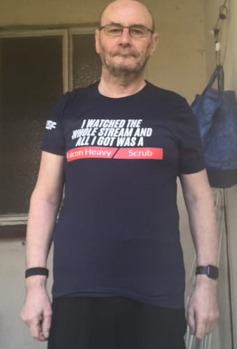 Customer wearing the navy blue Falcon Heavy Scrub - Unisex T-shirt.