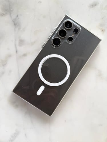 Reviewer's clear Magsafe case on a dark Samsung Galaxy S24 Ultra, showing the white magnetic ring on the back.