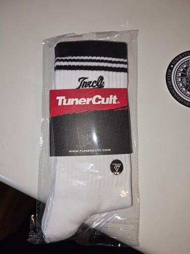 Customer's white and black SCRIPT CREW SOCKS in their original packaging.
