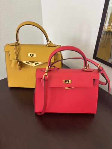 Customer's two Kally Leather Bags, one large and yellow and one small and red, displayed on a dark surface.