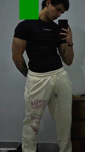 A reviewer wearing the black 475 SuperVillain Compression Tee, showing its tight muscle fit.