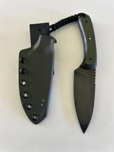 Customer showcases a finished knife with a smooth blade, demonstrating the results of the sanding belts.