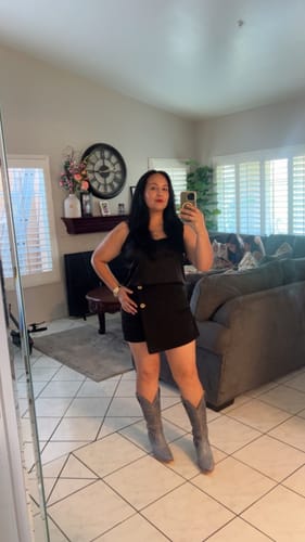 Reviewer shows off her tall, blue Annie Western Boots in a full-length mirror selfie.