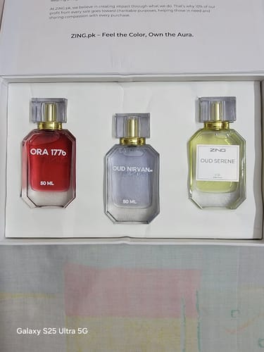 Reviewer's open OUD Supreme BUNDLE showing three elegant perfume bottles: Ora 1776, Oud Nirvana, and Oud Serene.