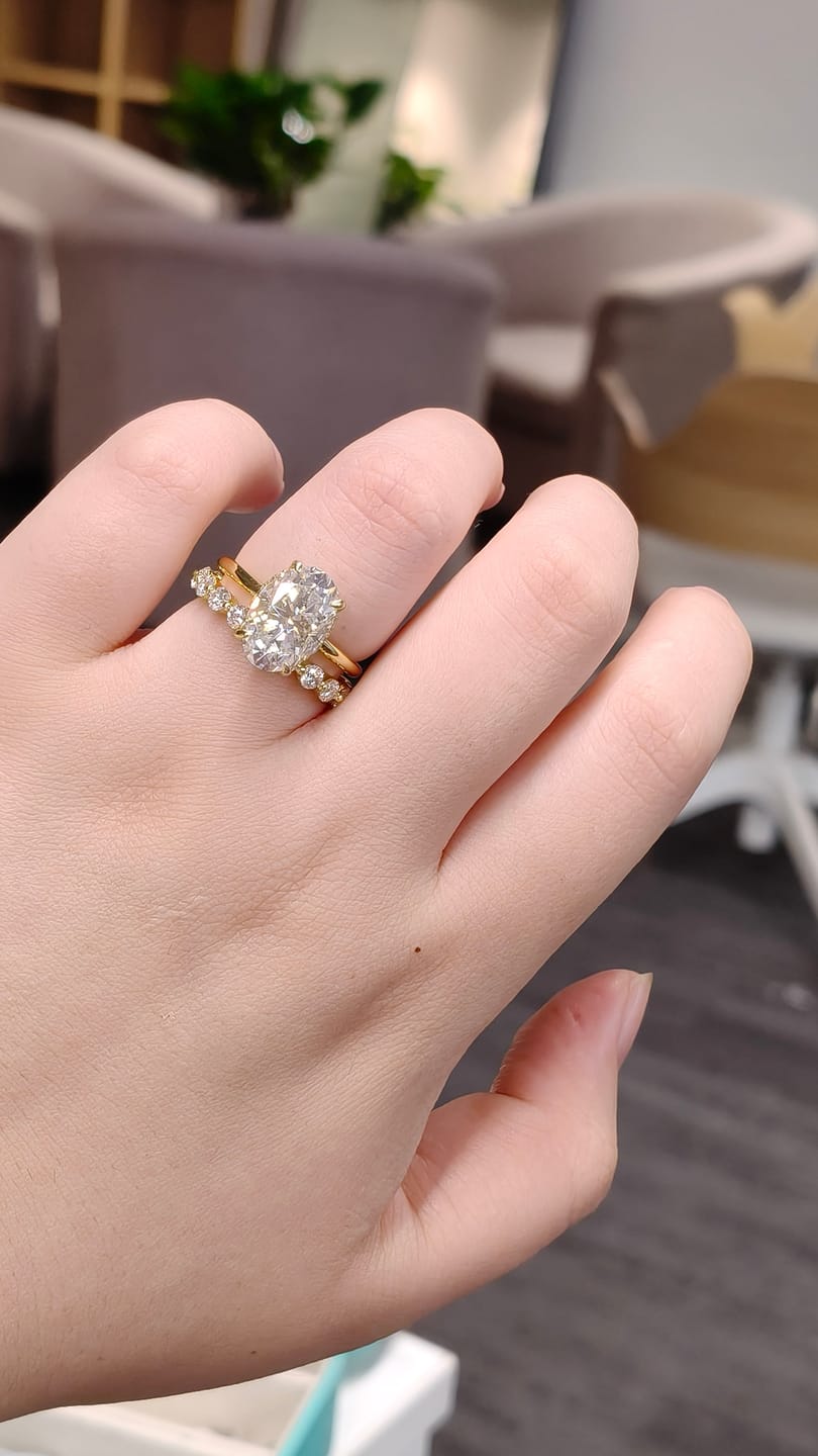 Customer photo review of Moissanite 4.0Ct Hidden Halo Oval Cut Yellow Gold Engagement Ring with 1.5Ct Round Cut Wedding Band