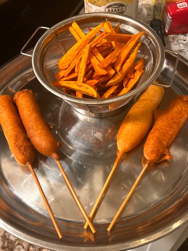 Reviewer's homemade corn dogs, made from Halal Chicken Franks, on a metal tray with fries.