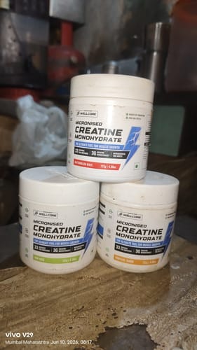 Customer's three white tubs of Wellcore Micronised Creatine Monohydrate stacked together on a surface.