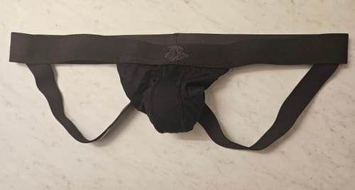 Customer's black Nylon Mesh Jockstrap laid flat on a counter, showing the waistband, pouch, and straps.