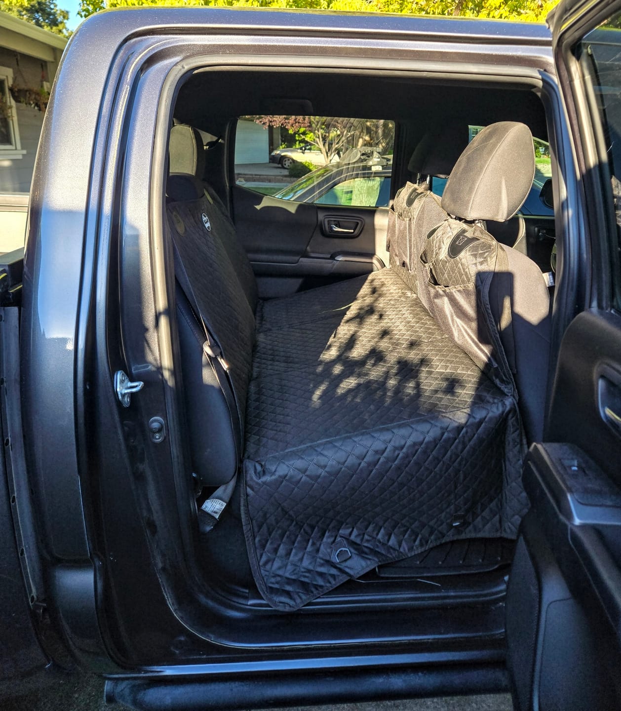 Customer photo review of NEW Waterproof Hard Bottom Car & Truck Seat Foldable Hammock Cover With Storage Pockets, Side Flaps, Headrest Straps, Seat Anchors, & Mesh Window (+FREE SAFETY BELT!)