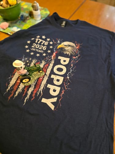 Customer's personalized 'POPPY' Patriotic Eagle shirt in navy blue, laid flat to show the eagle and American flag graphic.