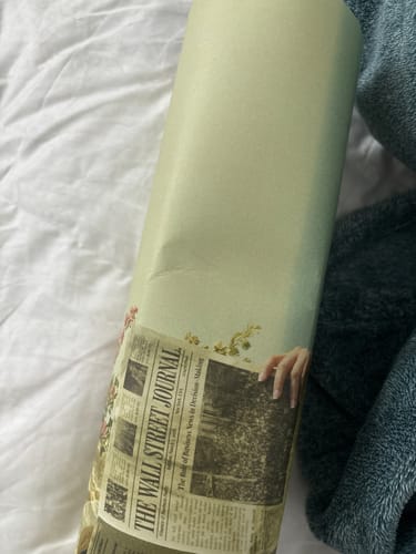 Reviewer's rolled La Dolce Niente N02 art print showing a noticeable crease from being crushed in transit.