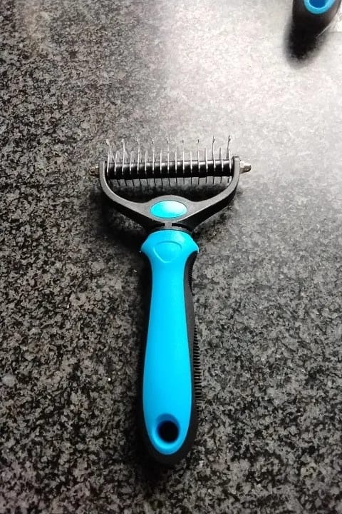 Customer photo review of Double-Sided Dog Dematting Comb & Deshedding Tool for Dogs & Cats