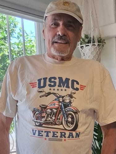 Customer smiling while wearing the off-white USMC Rider t-shirt with a patriotic motorcycle and 'VETERAN' graphic.