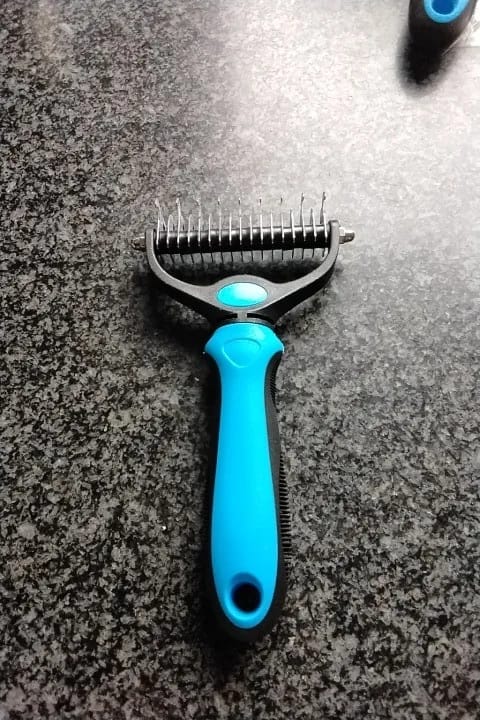 Customer photo review of Double-Sided Dog Dematting Comb & Deshedding Tool for Dogs & Cats