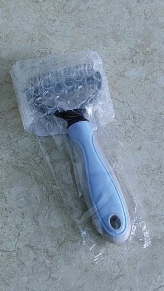 Customer photo review of Double-Sided Dog Dematting Comb & Deshedding Tool for Dogs & Cats