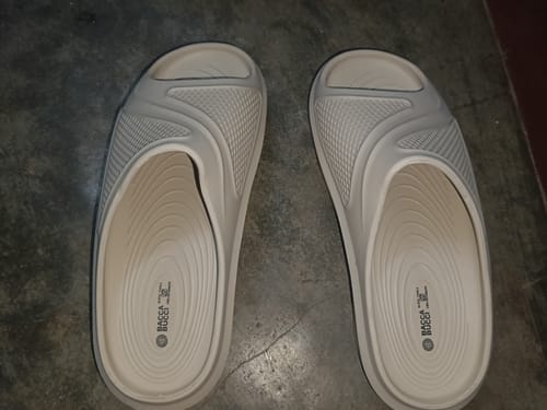Reviewer's pair of beige Floats slides on a floor, shown from a top-down angle.