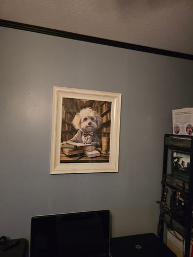 Reviewer's completed Dogstein painting, framed and hanging on a wall in a home office.