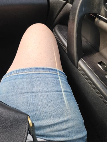 Close-up of a reviewer wearing the light wash Judy Blue shorts, which have been un-cuffed for length.
