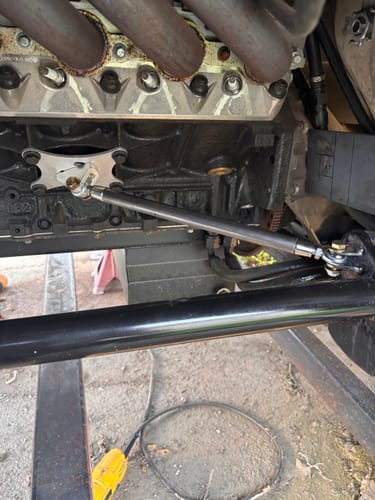 Reviewer's installed Motion Raceworks LS1 Engine Travel Limiter connecting the black engine block to the vehicle's chassis bar.