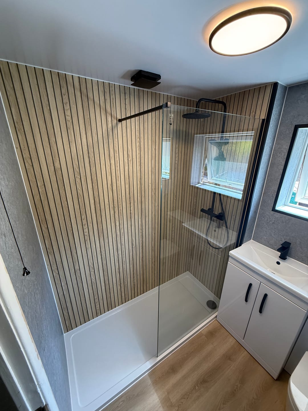 Customer photo review of Sivara Oak Slatted Wood Effect PVC Waterproof Shower Panel