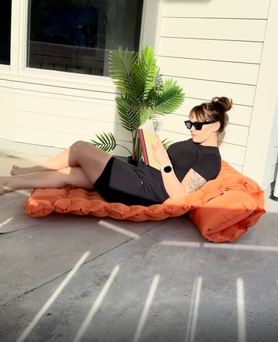 Reading on the Adventure Mat on the patio
