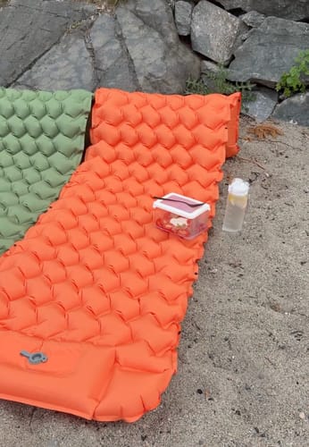 Two Adventure Mats on hard ground with snacks