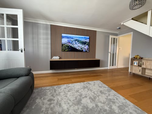 Reviewer's Premium Acoustic Wall Panels in Natural Oak installed as a feature wall behind a TV in their living room.