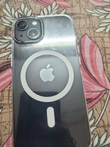 Reviewer's iPhone 13 fitted with the clear MagSafe case, showing the back with the white magnet.