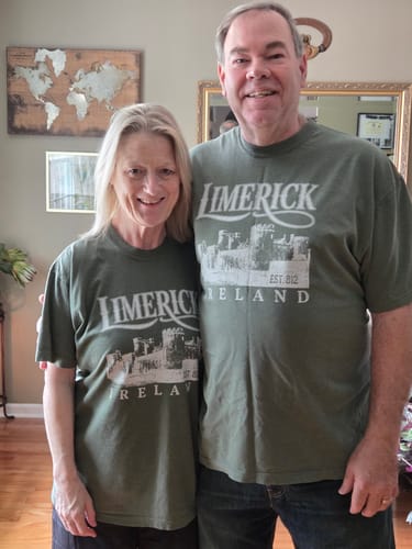 Reviewers wearing their matching green Limerick Ireland Vintage Print T-Shirts indoors.
