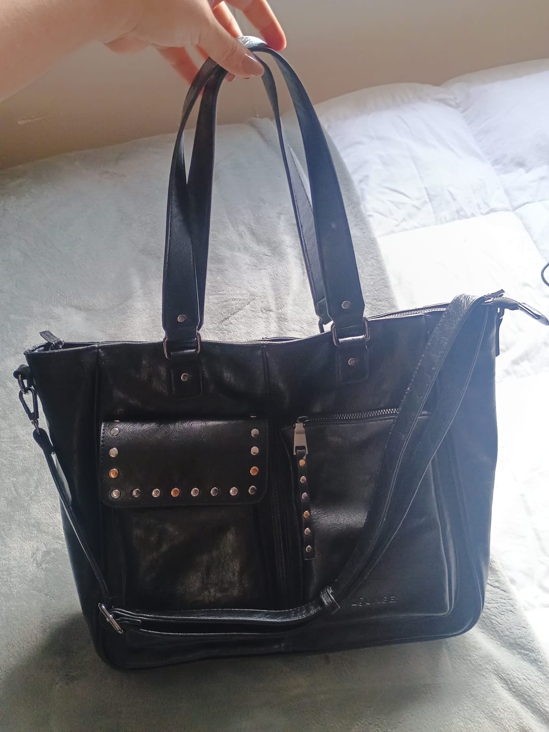 Customer photo review of Cartera Notebook Bolsillos Tachas