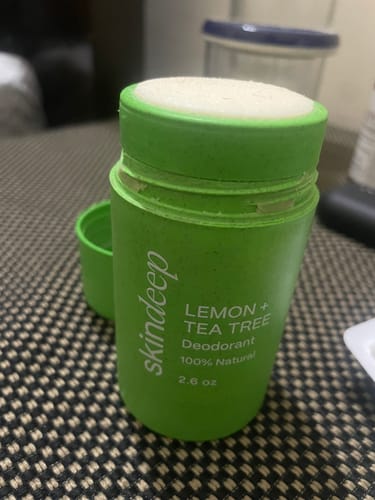 Customer's green deodorant stick with the cap off, showing the white deodorant refill.