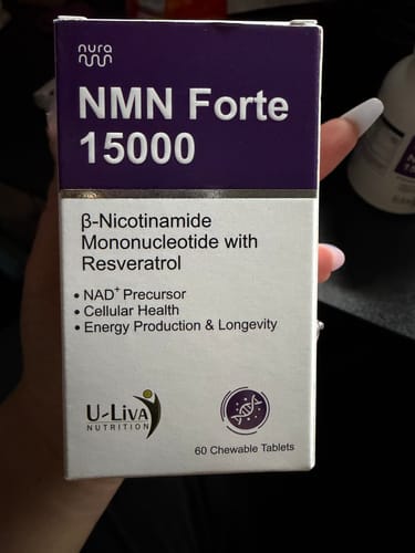 購入者が手に持っている「NMN Forte 15000」サプリメントの箱。