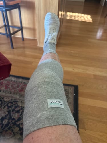 Customer relaxing indoors wearing the knee sleeve