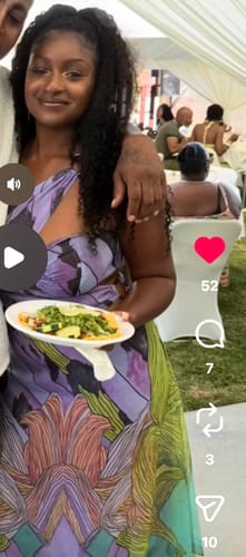 Reviewer smiling while wearing the colorful Chiffon Print Cutout Maxi Dress at an outdoor event.