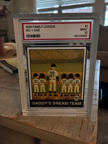 Customer's personalized 'No. 1 Dad' acrylic block plaque, styled as a baseball card, displayed on a wooden table.