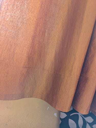 Reviewer's close-up image showing a textured, wood-grain surface.