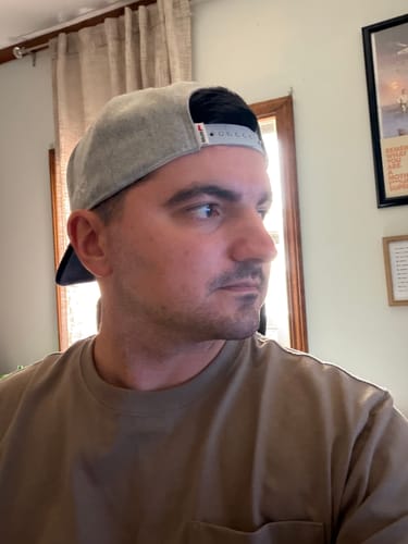 Reviewer wearing the Big Flat Bill Structured Wool Hat, showing the back with its double-snap snapback closure.