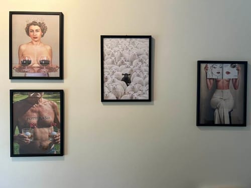 Customer's four Black Oak Gallery Frames displaying eclectic art prints on a light-colored wall.