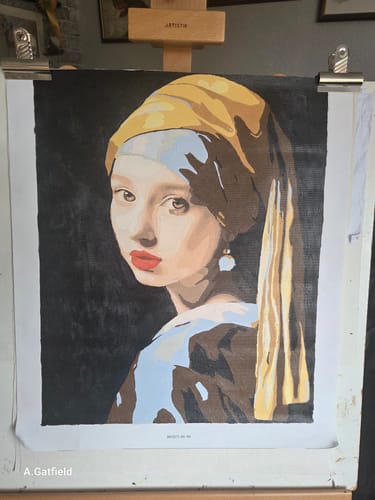 Customer's completed Timeless Gaze paint-by-numbers project, a version of 'Girl with a Pearl Earring', on an easel.
