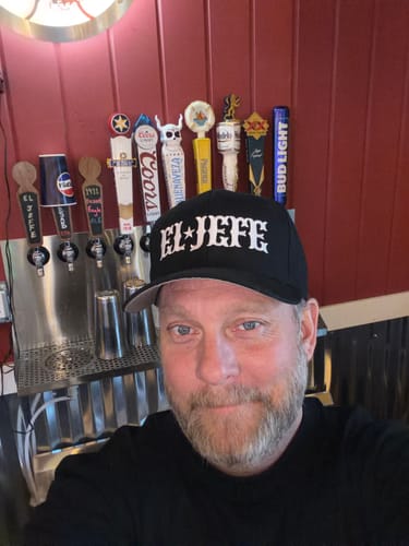 Customer wearing the El Jefe OG Otto Snapback Hat in a close-up selfie.