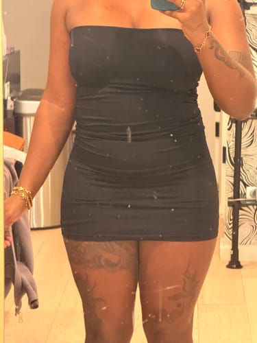 Customer's mirror selfie showing the compressive, body-hugging fit of the black Seamless Tube Mini Dress.