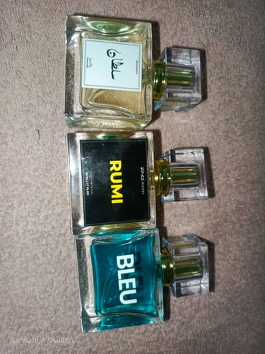 Customer's Sultan perfume bottle, with a white label and Arabic script, displayed with two other fragrances.