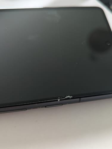Customer's close-up of their refurbished Google Pixel 7 showing a cracked screen near the volume buttons.