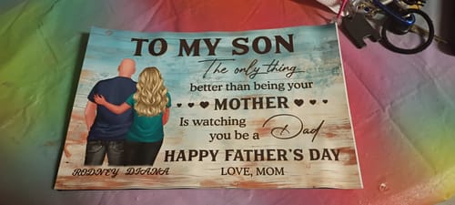 Customer's personalized 'To My Son' poster laid out, showing the heartfelt message and a graphic of a mother and son.