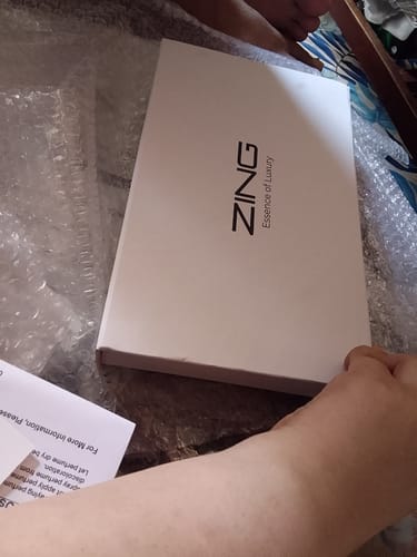 Reviewer unboxing the white branded box of the OUD Supreme BUNDLE.