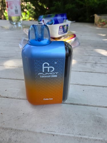 Customer's blue and orange Randm Tornado 20000 vape in Cola Ice flavor on an outdoor table.