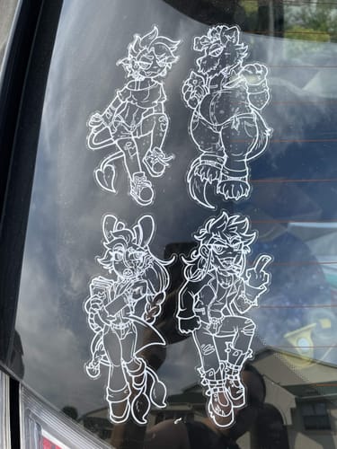 Customer's four white custom vinyl decals with detailed character art applied to a car window.